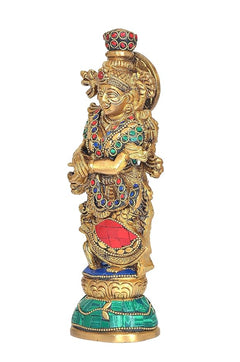 Brass Radha Krishna statue side view, jeweled crown, red-blue skirt, arms crossed