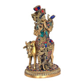 Brass Govinda cow idol, side view with jeweled ornaments and detailed base
