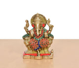 Brass Ganesha figurine close front, ornate crown, red ear ornaments, layered bead jewelry