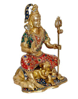 Brass Shiva statue seated with trident, jeweled red-green outfit and ornate headpiece