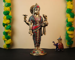 Brass Dhanvantari idol with red-green stonework, one hand raised in blessing