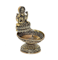 Brass Lakshmi diya oil lamp figurine, angled view with patterned base and tray