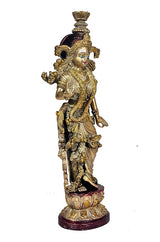 Brass Radha Rani figurine side view, draped sash and ornate ornaments, on dark base