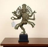Vintage bronze Nataraj Lord Shiva dancing statue on dark base, arms extended, detailed figure