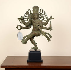 Vintage bronze Nataraj Lord Shiva dancing statue on dark base, arms extended, detailed figure