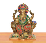 Brass Ganesha statue seated on singhasan with jeweled multicolor attire and hands raised