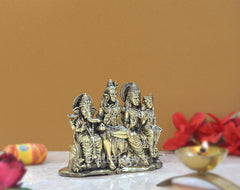 Brass Shiv Parivar family idol, angled view showing multiple crowned deity figures