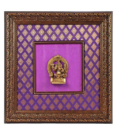 Brass Lord Ganesha idol centered in ornate wooden frame, purple cloth backdrop