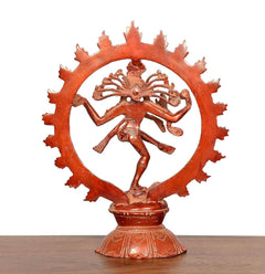 Dancing Lord Shiva figurine in wide circular halo, multicolour red finish, angled view