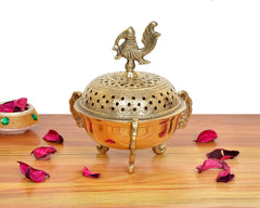 Golden brass loban dhoop dani with peacock ornament and dome perforations