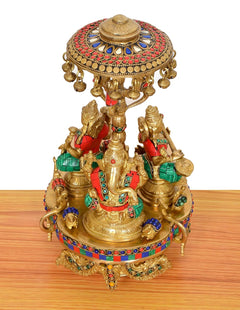 Brass Lakshmi-Ganesha-Saraswati idol with colorful paneling on moving base, parasol top