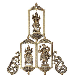 Brass Dashavatara wall hanging showing top deity and two central arched panels