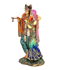 Radha-Krishna idol statue from side, Krishna holding flute while Radha leans close