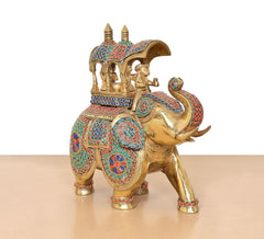 Side view brass king on elephant statue with colorful mosaic details and decorated headpiece
