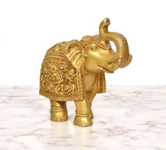 Brass elephant figurine rear-side view, trunk up and ornate relief pattern