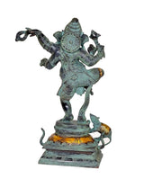Rear view of dancing Ganesha idol statue with turquoise finish, gold details on base