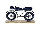 Black iron bike decorative statue with spoked wheels and curved handlebars on base