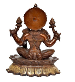 Brass Lakshmi idol statue, back view with circular halo and seated lotus posture