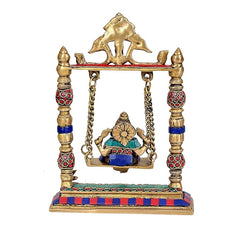 Back view of brass Ganesha swing idol with gold back panel and blue base