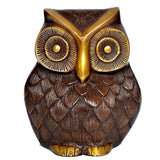 Close-up brass owl with embossed feather scales and golden beak and eye rims.