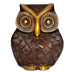 Close-up brass owl with embossed feather scales and golden beak and eye rims.