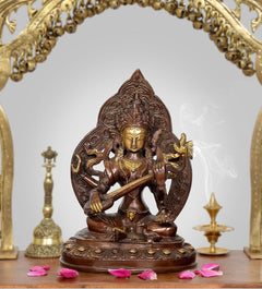 Brass Tara Devi statue, seated lotus pose holding a staff with ornate halo