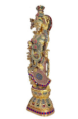 Brass Radha Rani sculpture side view with red-green accents and patterned jewelry
