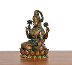 Lakshmi brass idol, angled side view with four arms and lotus-like hand details
