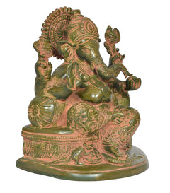 Brass green Ganesh statue, angled view, ornate robe, raised hand gestures, round base