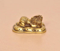 Brass Baby Ganesh statue, golden tone, opposite angle with ornate base details
