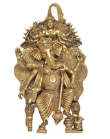 Golden Ganesha idol statue with trunk detail, ornate crown, and seated pose