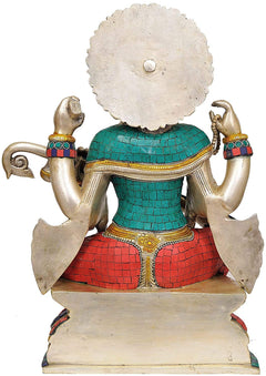 Back view brass Saraswati idol seated on base, teal-red mosaic back panel
