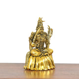 Golden brass deity statue seated on lotus base, ornate crown and side ornaments