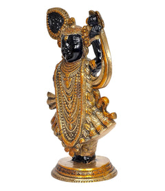 Side view Brass Shreenathji figurine in ornate gold patterned dress, arched arm pose