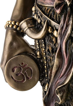 Shiva torso close-up with Om symbol medallion, bronze-tone bracelets and garland