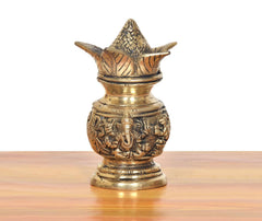 Brass kalash showpiece with carved Lakshmi & Ganesh, peaked top design