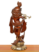 Back view of Krishna idol playing flute, carved hair and shoulder drape, on pedestal