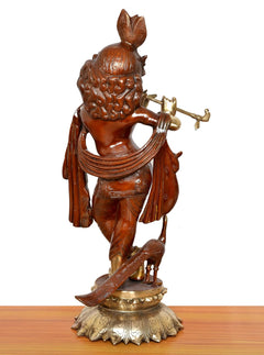 Back view of Krishna idol playing flute, carved hair and shoulder drape, on pedestal