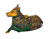 Brass Nandi bull statue side view, golden head, green body, and ornate patterned saddle