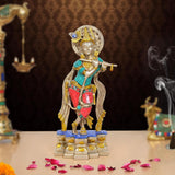 Krishna flute idol sculpture, front view; brass figure with blue and red jeweled outfit