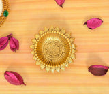Golden metal oil diya lamp with detailed mandala-style center and ornate outer rim