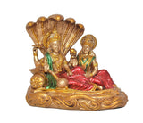 Vishnu and Lakshmi seated on coiled Sheshnag with gold detailing and red garments