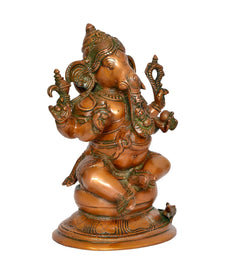 Brass Ganesha statue back/left angle, seated figure with carved jewelry and arms