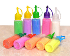 Assorted rangoli powder tubes lying in front view, multicolor bottles and caps
