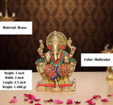 Brass Ganesha statue front view with raised hands, red-and-gold patterned garment, beads