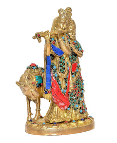 Side view of Radha-Krishna brass cow statue, jeweled blue-red dress and ornaments