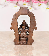 Copper Ganesha statue back view inside a large ornamental arch
