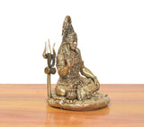 Brass Lord Shiva statue front-side view, seated blessing posture with trident, lion head base