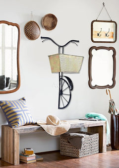 Black bicycle wall planter with cream mesh basket and wheel; hanging hooks on frame