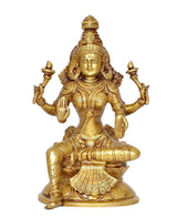 Brass Lakshmi goddess statue, four arms raised, seated on lotus base